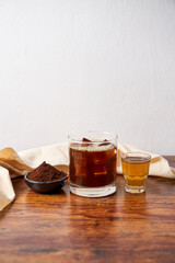 Wall Mural - Carajillo, cocktail made of coffee, liquor and ice, on a wooden table.