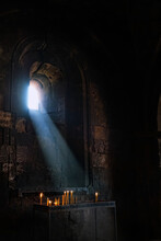 Interior Of Ancient Church. Burning Candles On Candlestick In Old Stone Monastery, Dark Blurred Abstract Background. Religious, Mourning Concept. Symbol Of Lent, Faith In God, Prayer.