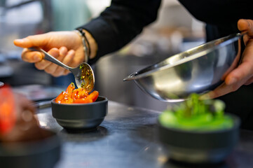 Chef cooking vegetables salad on restaurant kitchen