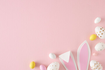 Wall Mural - Easter celebration concept. Top view photo of yellow pink white eggs easter bunny ears on isolated pastel pink background with empty space. Holiday card idea