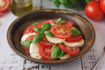 A bowl with traditional Italian caprese salad	