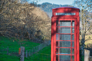 Wall Mural - A traditional english red phone booth in Candaneu village, Pilona, Asturias, Spain