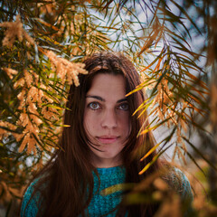 Pretty girl under mimosa trees