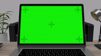 Mock-up Green Screen Laptop Standing on the Desk in the Modern Creative Office. Camera Zoom in Movement.
