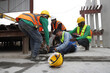 © sittinan - Accident at work of construction worker at site. Safety team helps employee accident.