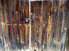 The Old Wooden Door Is Closed With An Old Lock