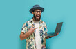 © San4ezz007 - Young crazy bearded charismatic man. Shocked or surprised expression. Laptop concept. Funny promotion poster. Programmer, web developer holding a laptop in his hands and looking at the camera