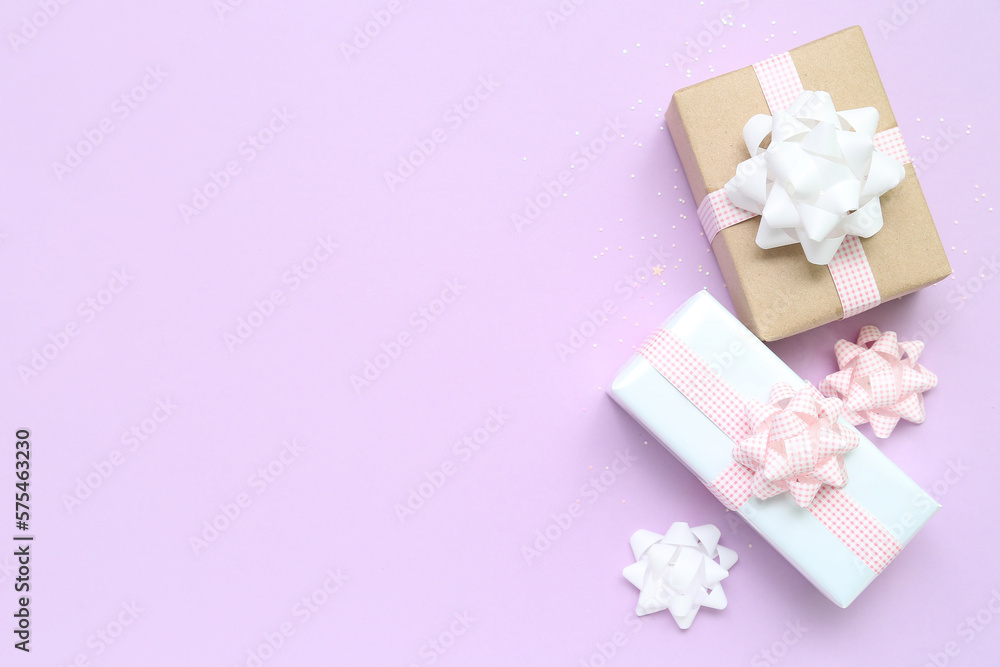 Gift boxes with bows on lilac background