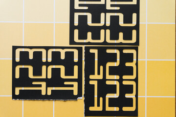 Sticker - stencil with 123 on yellow paper pad sheet with paint-chip pattern and coloration