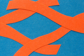 Sticker - overlapping orange felt stripes on blue felt backdrop