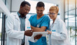 © Anela R/peopleimages.com - Doctor, team and tablet in healthcare planning for research, idea or meeting on technology at hospital. Happy group of doctors with touchscreen for medical data, collaboration or teamwork strategy