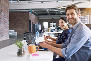 Wall Mural - Teamwork, office and portrait of man and woman at desk with laptop at creative agency, working on project together. Leadership, partnership and happy employees or business partner at design startup.