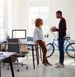 © A.B./peopleimages.com - Conversation, idea and black woman with man in office sharing opinion and meeting for creative project. Teamwork, planning proposal and employees in casual discussion at tech startup or design agency