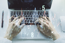 Abstract Creative Financial Graph With Hand Typing On Laptop On Background, Forex And Investment Concept. Multiexposure