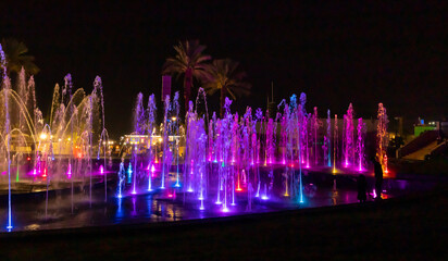 Enchanting grandiose musical performance - water and light show of a musical fountain on the embankment, in the center of the city of Eilat in southern Israel