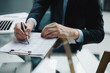© ty - Image of businessman hands taking business notes at office.