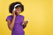 © Iván Moreno - Afro woman listening to music with mobile phone and headphones