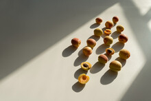 Aesthetic Fruit Background. Ripe Juicy Peaches On White Background With Sunlight Shadows. Fresh Organic Fruit Vegan Food