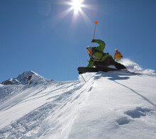 Low Perspective Of Two Skiers On Mountain Slope
