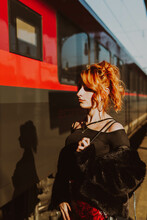 Red-haired Woman In Train Station Waiting The Train