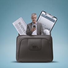 Businessman And Financial Items In A Briefcase