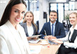 © ty - business woman with her staff, people group in background at modern bright office indoors.