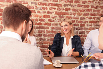 Canvas Print - Businesswoman having meeting with her employees in office. Lady boss