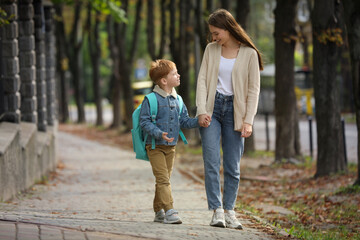 Canvas Print - Young mom taking her son to school