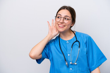 surgeon doctor woman holding tools isolated on white background listening to something by putting hand on the ear