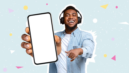 Wall Mural - Happy black man using headphones, showing smartphone, mockup