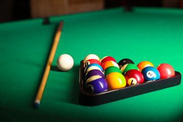 Sticker - Plastic triangle rack with billiard balls and cue on green table, closeup