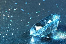 Beautiful Diamond On Shiny Light Blue Background, Closeup. Space For Text