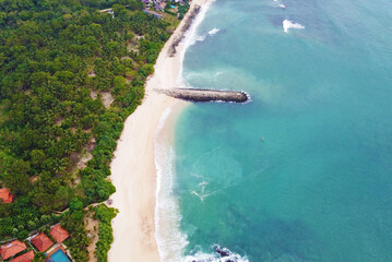 Wall Mural - Aerial view of the tropical ocean landscape with a beach. Beautiful southern sea wallpaper for tourism and advertising. Asian landscape, drone photo