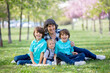 © Tomsickova - Cute children in the park with grandmother, springtime