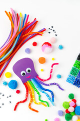 Wall Mural - Funny octopus made of beads and pipe cleaners with different colorful and materials for DIY art activity for kids. Cute children's crafts, creativity and hobby. Development of fine motor skills