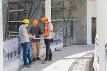 Wall Mural - Engineer, foreman, Architect, contractor and worker discussing about project in building construction site.