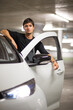 © lightpoet - Underground parking/garage (shallow DOF; color toned image) - young male driver with his small city electric car