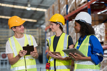 Male And Female Warehouse Workers Working And Standing Talking Together At The Storage Warehouse. Group Of Warehouse Workers Discuss And Training Work In Distribution Branch