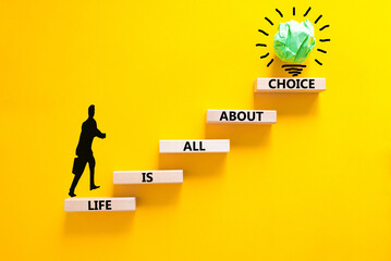 Choice and life symbol. Concept words Life is all about choice on wooden blocks. Beautiful yellow table yellow background. Businessman icon. Business choice and life concept. Copy space.