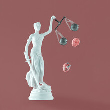 Pastel White Statue Of Lady Justice With Human Heart And Brain Fall Out Of Scales On Isolated Maroon Background. Abstract Concept Of Law, Anger, Unfairness. Symbol Of Power Of Objectivity And Justice.