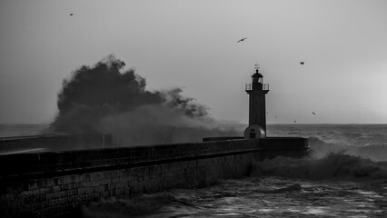 Poster - Lighthouse with a huge wave on the Atlantic, Porto, Portugal. Black and white photo.