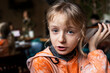 © Nataliia Makarovska - portrait of a little girl with blond hair listening to a lesson on the phone. horizontal