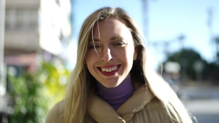 Sticker - Young blonde woman smiling confident standing at street