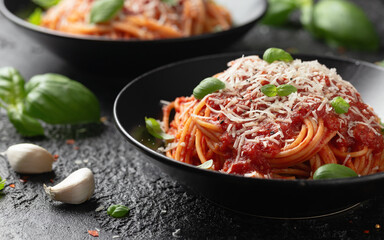 Wall Mural - Italian marinara sauce spaghetti pasta served with fresh basil, olives and pecorino cheese