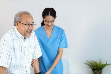 Wall Mural - Asian nurse support senior elderly male, Asian older aged man doing physiotherapist in home living room using walker workout exercise for patient with caregiver in health insurance nursing care