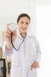 © jokekung - asian doctor holding stethoscope in clinic, she feeling happy and smile in hospital
