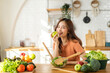 © Art_Photo - Portrait of beauty body slim healthy asian woman having fun cooking and preparing cooking vegan food healthy eat with fresh vegetable salad in kitchen at home.Diet concept.Fitness and healthy food