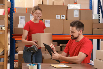 Canvas Print - Post office workers checking parcel barcode indoors