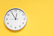 © New Africa - Stylish round clock on yellow background, top view with space for text. Interior element