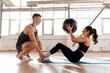© Богдан Маліцький - athletic couple in sportswear train with ball in the morning, fitness girl does exercise on the press with trainer